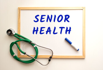 There is a stethoscope on a white board background and the word is written. Medical concept.