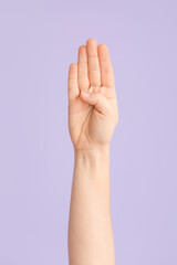 Hand showing letter B on color background. Sign language alphabet