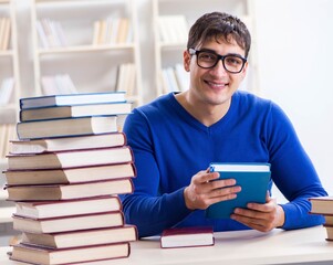 Male student preparing for exams in college library