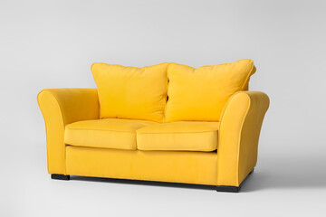 Stylish sofa on light background