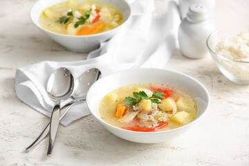 Bowl of tasty rice soup on table