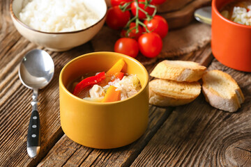 Bowl of tasty rice soup on table