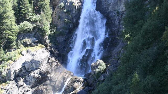 The water flows foaming from the Rutor waterfall, in the Aosta Valley