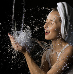 Happy girl washing her face isolated shot