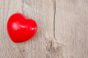 red heart on wood background. View from above. Copy of space.