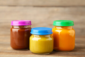 Jars of baby puree on grey background. Fruit and vegetables puree