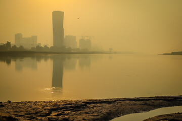 Obraz premium Sunrise Sky view background behind capital gate tower of Abu Dhabi, Skyscrapers in Capital city of United Arab Emirates