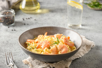 Italian pasta fettuccine with shrimps on gray. Close up.