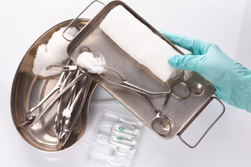 Dental appliances in sterile packaging. Dentist's hand in gloves