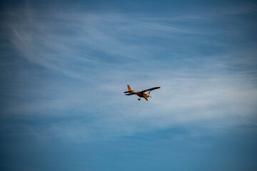 yellow rare plane against the blue sky