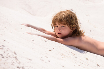 Sun protection. Child relaxing on the beach against sea and sky background. Summer vacation and travel concept.