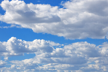 blue sky with white curly fluffy clouds