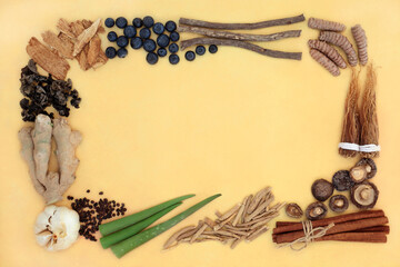 Adaptogen health food border with natural plant based herbs, spices & foods that help the body deal with stress &  promote or restore normal physiological functions. On mottled yellow background.