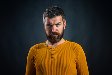 Portrait of confident serious man has beard and mustache on black isolated. Hipster guy models in studio. Handsome male model, closeup face.