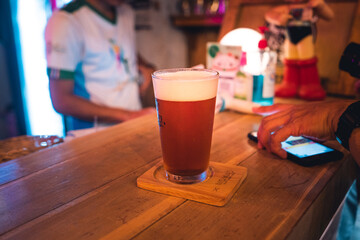 Beer poured into glasses in the bar at night.