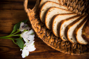 on a wooden table in a basket are slices of sliced white bread