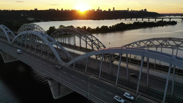 Moving Away From The Bridge, Sunset Over The City Bridge And River Beautiful View