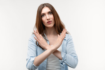 Photo of Serious girl gesturing stop, finish, symbol of rejection, not allow violence, body language