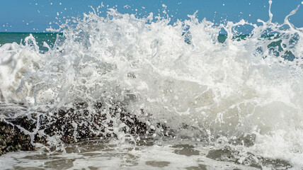 Splashes from ocean waves breaking on the reef, Recife beach, Brazil
