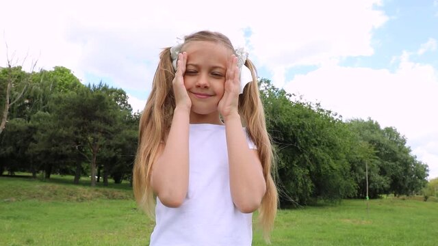 peek a boo. little girl covered her eyes face with her hands hide-and-seek lifestyle waiting for a surprise. a little girl covers her face with her hands. the child plays