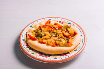 Freshly baked mini pizza сoca with chicken and onions. Traditional Spanish pastry with vegetables.