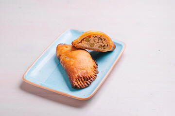 empanada, meat pie on a plate and white background