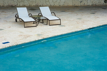 Swimming Pool at tropical beach - summer vacation background.