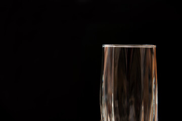 Just a glass on black background, horizontal photo  with copy space.