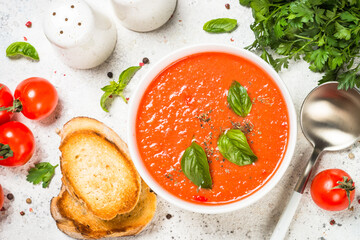 Tomato soup at white table.