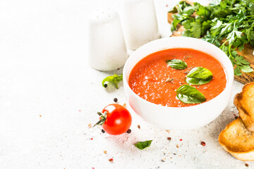 Tomato soup at white table.