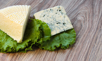 Cheese with a noble mold with lettuce leaves.