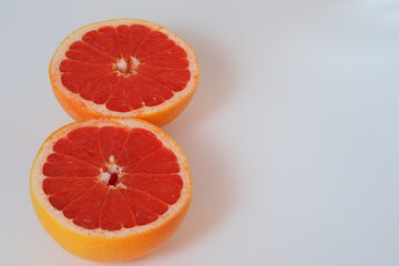Fruits are citrus fruits. Red grapefruit cut in half. High