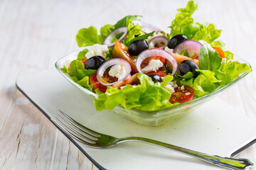 Greek salad with feta cheese, black olives and onion