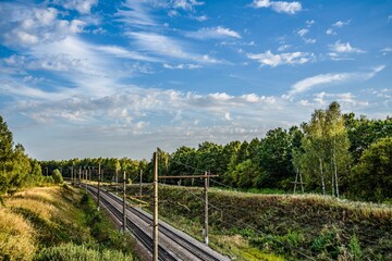 Fototapeta na wymiar Railroad and beautiful sky on an early autumn evening in September.