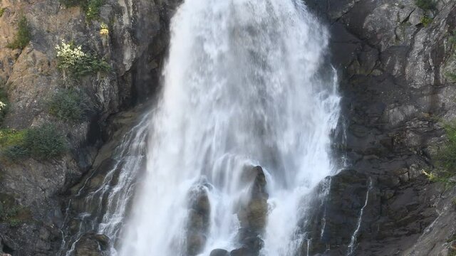 The water flows foaming from the Rutor waterfall, in the Aosta Valley
