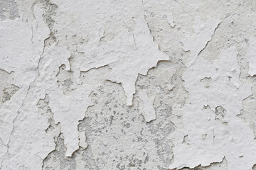 Peeling paint of white wall.Closeup of peeling painted wall.Grungy cracked white wall paint peeling off.