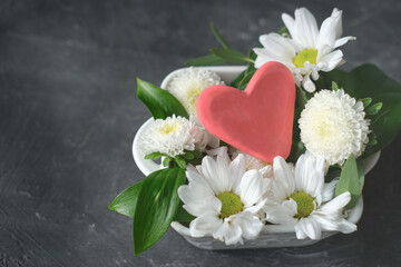 white flowers and red heart in a vase, health care, love and support, organ donation, family insurance and CSR concept, world heart day, world health day, National Organ Donor Day. 