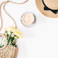 Summer trendy composition. Flowers, straw bag, straw hat and cup of coffee on white background. Autumn background. Flat lay, top view, copy space