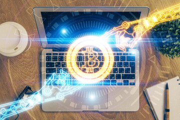 Multi exposure of blockchain theme hologram and table with computer background. Concept of bitcoin crypto currency.