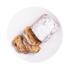 Traditional Christmas stollen cake isolated on white. Fruit bread with nuts, spices and dried fruit. Top view.