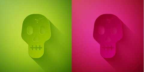 Paper cut Skull icon isolated on green and pink background. Happy Halloween party. Paper art style. Vector.