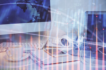 Stock market graph and table with computer background. Multi exposure. Concept of financial analysis.