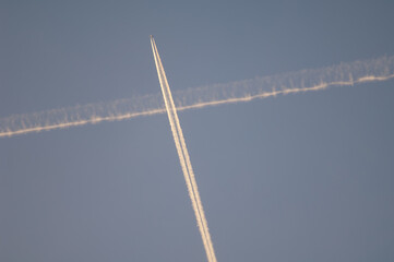 Airplane and contrail of another airplane in the sky. Huesca. Aragon. Spain.