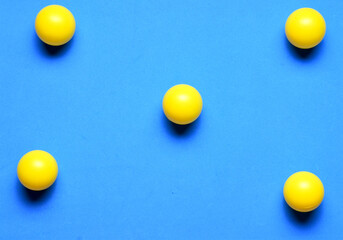 Group of yellow balls in line, on blue background