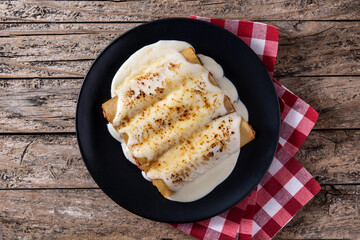 Delicious meat cannelloni pasta on wooden table.Top view	