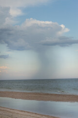 A seascape with a cloud and rain