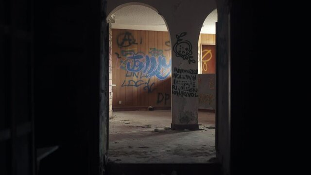 Walking through abandoned derelict building, graffiti and street art on walls