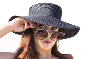 Close-up portrait of a woman on a white background. A young woman with a hat and sunglasses