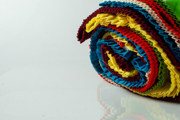 Roll of colourful cotton cloths with frills ready to be stitched