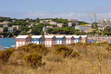 Fototapeta na wymiar Colorful huts for bathers on the Costa Brava